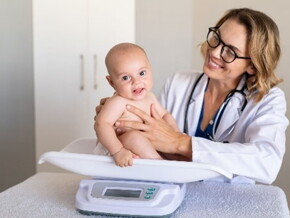 Doctora pesando al bebé.